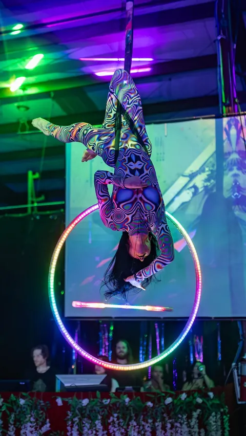 LED lyra performed with a levitation wand under club lighting