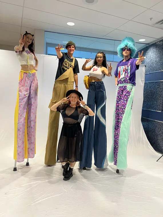 Caroline stilt walking in a 90s themed costume at EDC Las Vegas