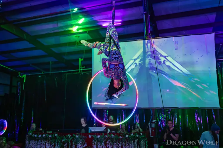 Aerial hoop performance combined with a glowing LED levitation wand