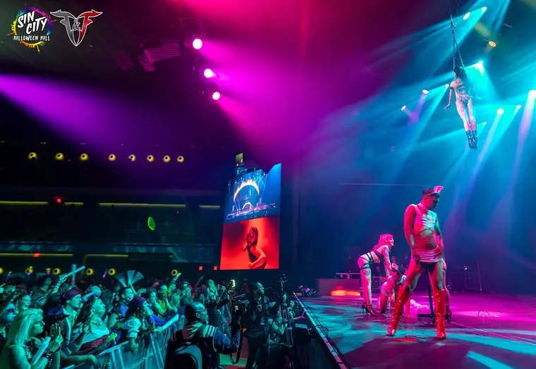 Caroline performing on aerial chains at the Sin City Halloween Ball