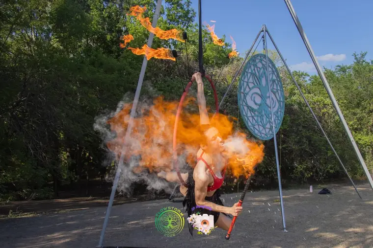 Fire breathing performed while suspended on an aerial apparatus