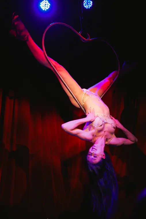 Burlesque styled aerial heart routine in red light