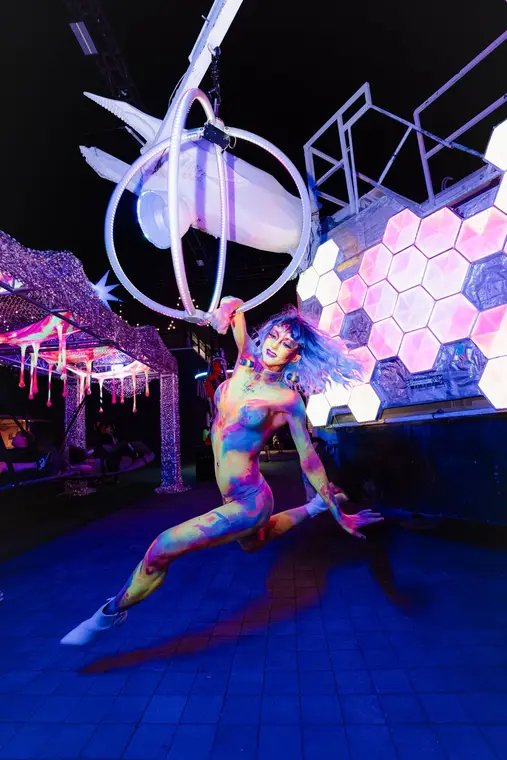 Alien character performing inside the aerial sphere at AREA15