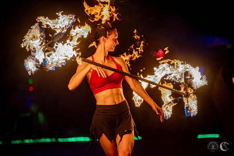 Spinning a large fire dragon staff at night