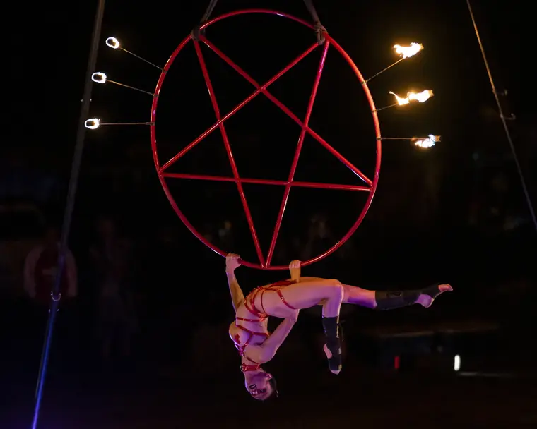 Caroline suspended inside the burning aerial pentagram