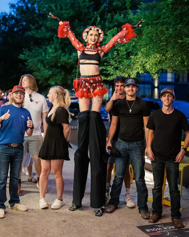 Guests posing with the mushroom stilt character